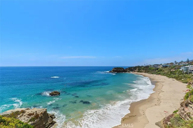 a dining room with furniture a chandelier and wooden floor