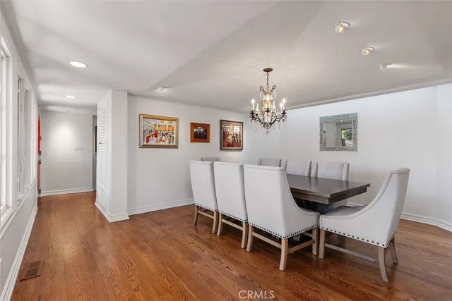 a kitchen with stainless steel appliances wooden floor and a large window