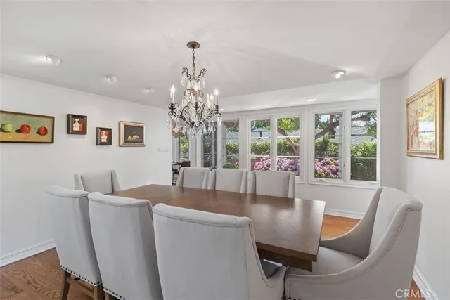 a dining hall with stainless steel appliances kitchen island granite countertop a dining table chairs and view living room