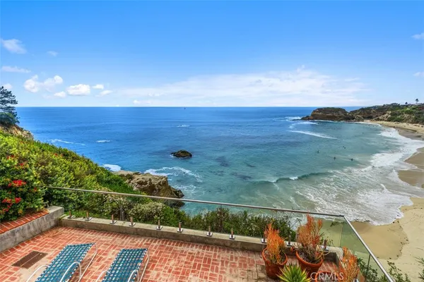 a view of a balcony with furniture and a garden