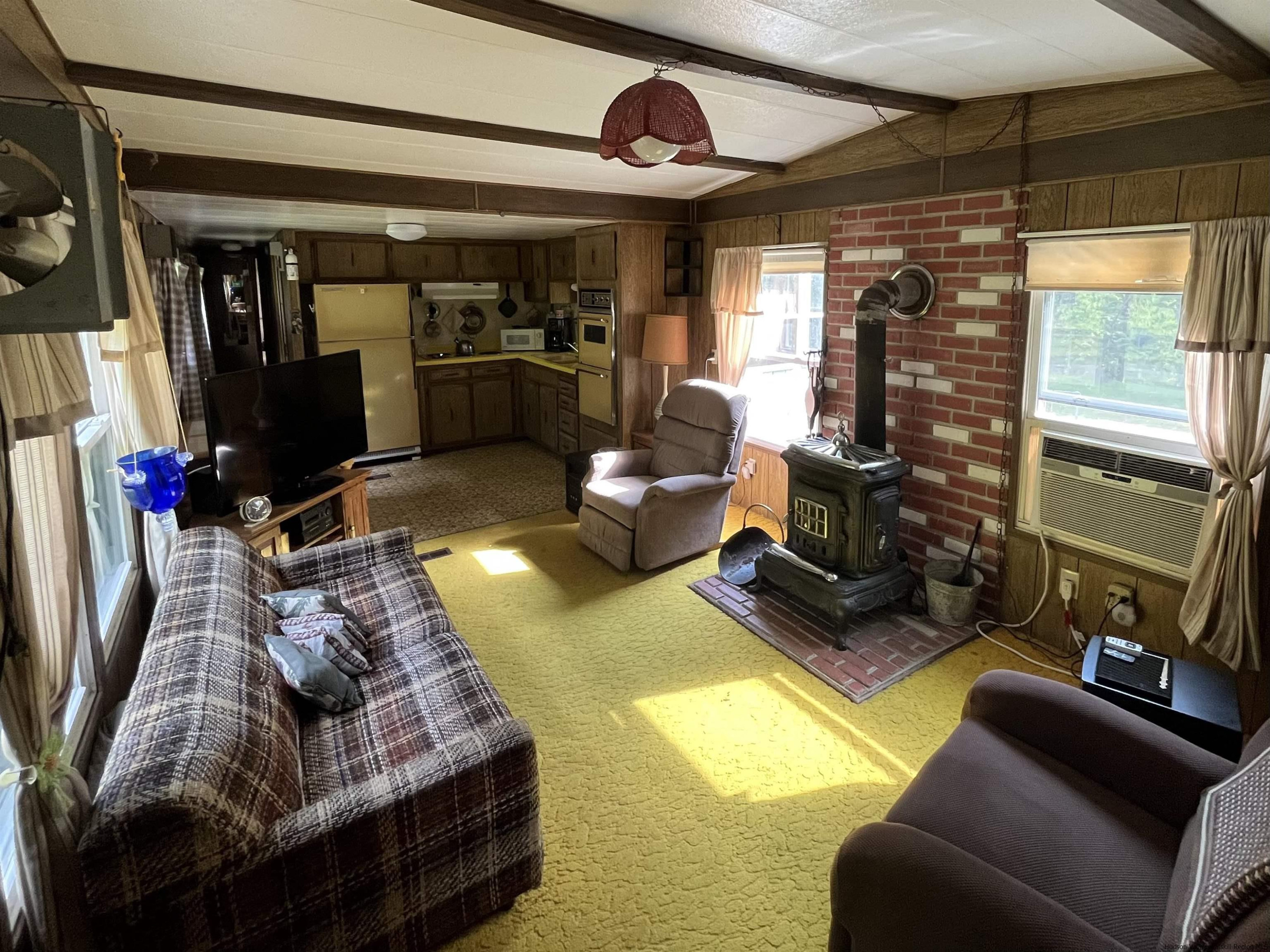 1882 High Falls Road Catskill, NY 12414 - Photo 6 of 18 a living room with furniture gym equipment and a large window