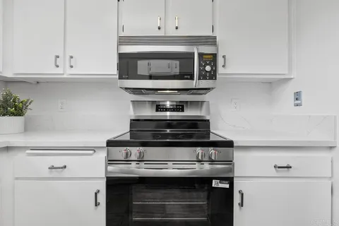 a stove top oven sitting inside of a kitchen
