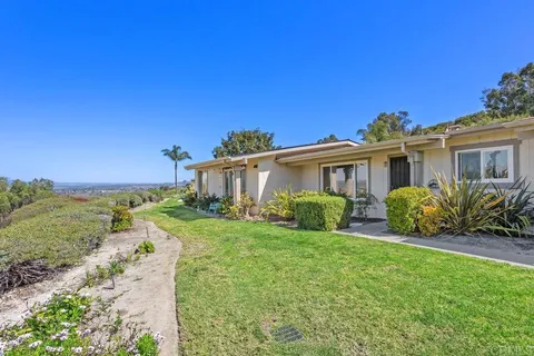 a view of a house with backyard and porch