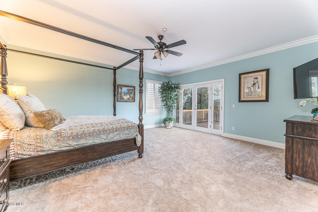 14176 Maya Circle Moorpark, CA 93021 - Photo 21 of 53 a bedroom with a large bed and a chandelier