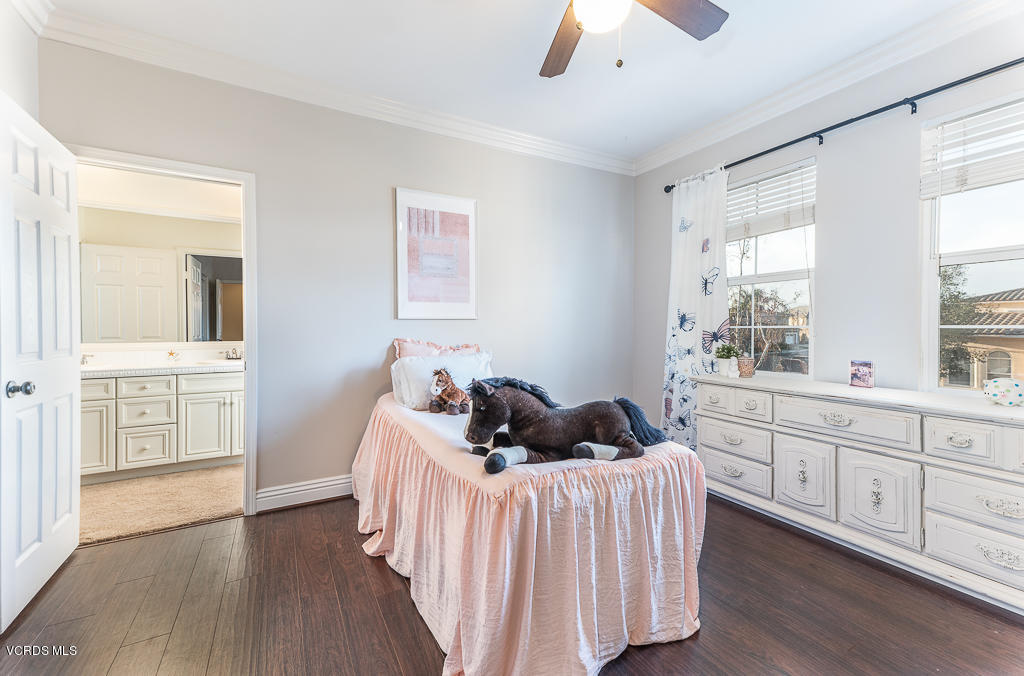 14176 Maya Circle Moorpark, CA 93021 - Photo 35 of 53 a bedroom with a bed and wooden floor