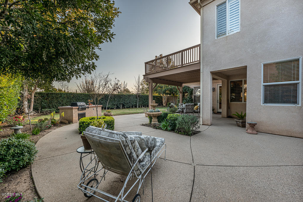 14176 Maya Circle Moorpark, CA 93021 - Photo 43 of 53 a view of a patio with table and chairs potted plants with wooden fence