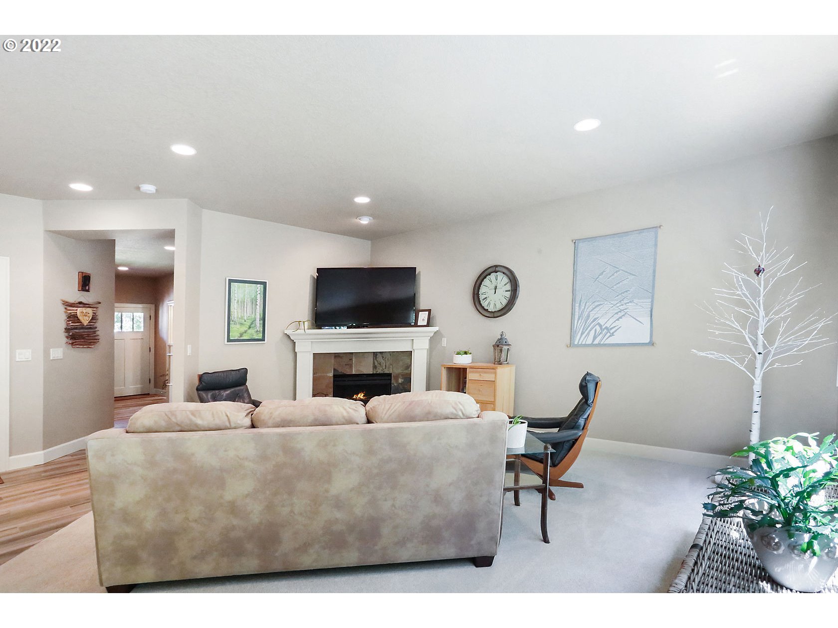 1773 Joseph Fields Street West Linn, OR 97068 - Photo 8 of 32 a living room with furniture a flat screen tv and a wall painting