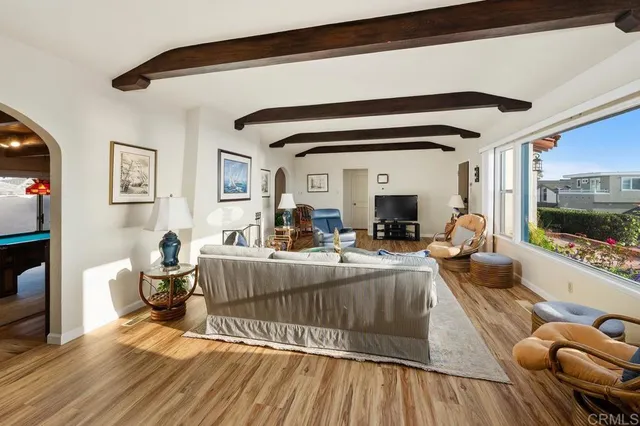 a dining room with furniture a chandelier and wooden floor