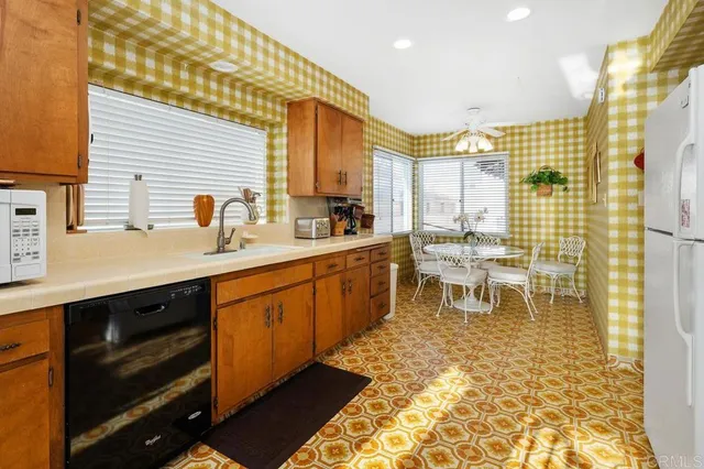 a kitchen with stainless steel appliances granite countertop a refrigerator and a stove