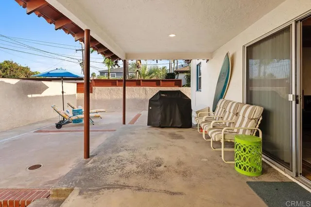 a view of a porch with furniture and floor to ceiling window