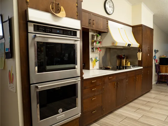 a kitchen with granite countertop cabinets and steel stainless steel appliances