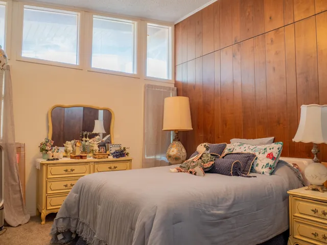 a bedroom with a bed and a window