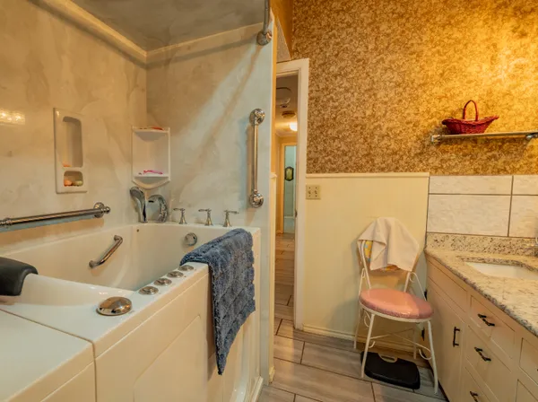 a bathroom with a tub and a sink