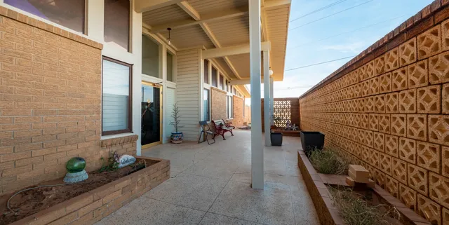 a view of a house with backyard sitting area and porch
