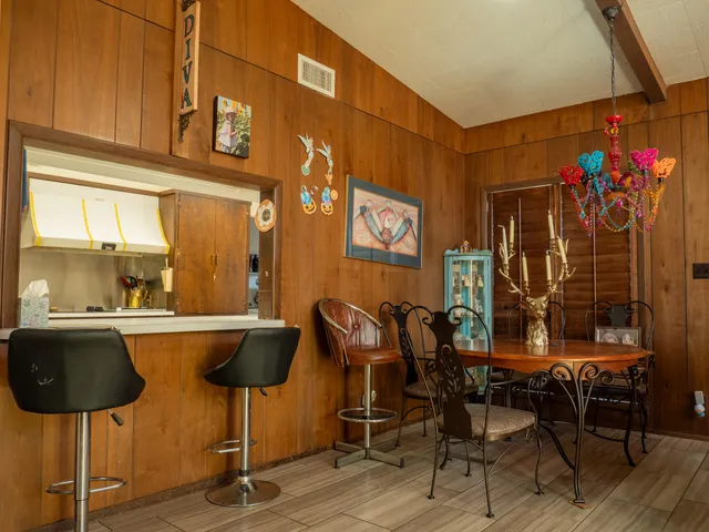 a view of a dining room with furniture and chandelier