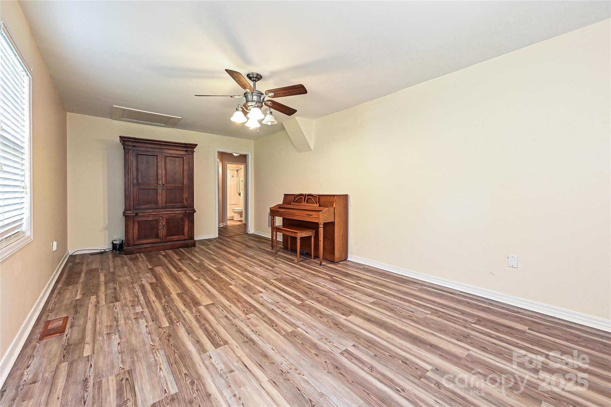 7705 Red Robin Trail Denver, NC 28037 - Photo 14 of 27 a view of a livingroom with wooden floor and a ceiling fan