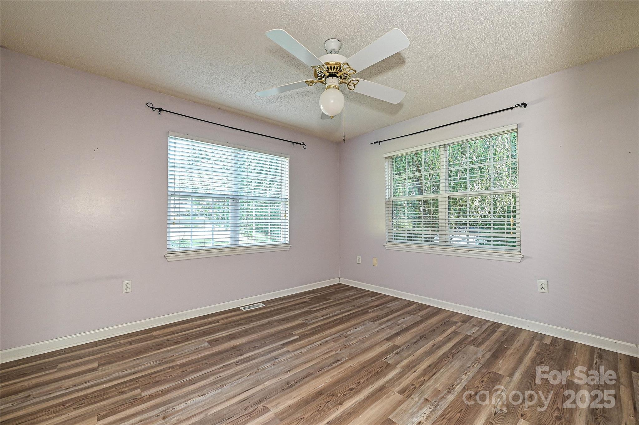 7705 Red Robin Trail Denver, NC 28037 - Photo 15 of 27 a view of an empty room with wooden floor and a window