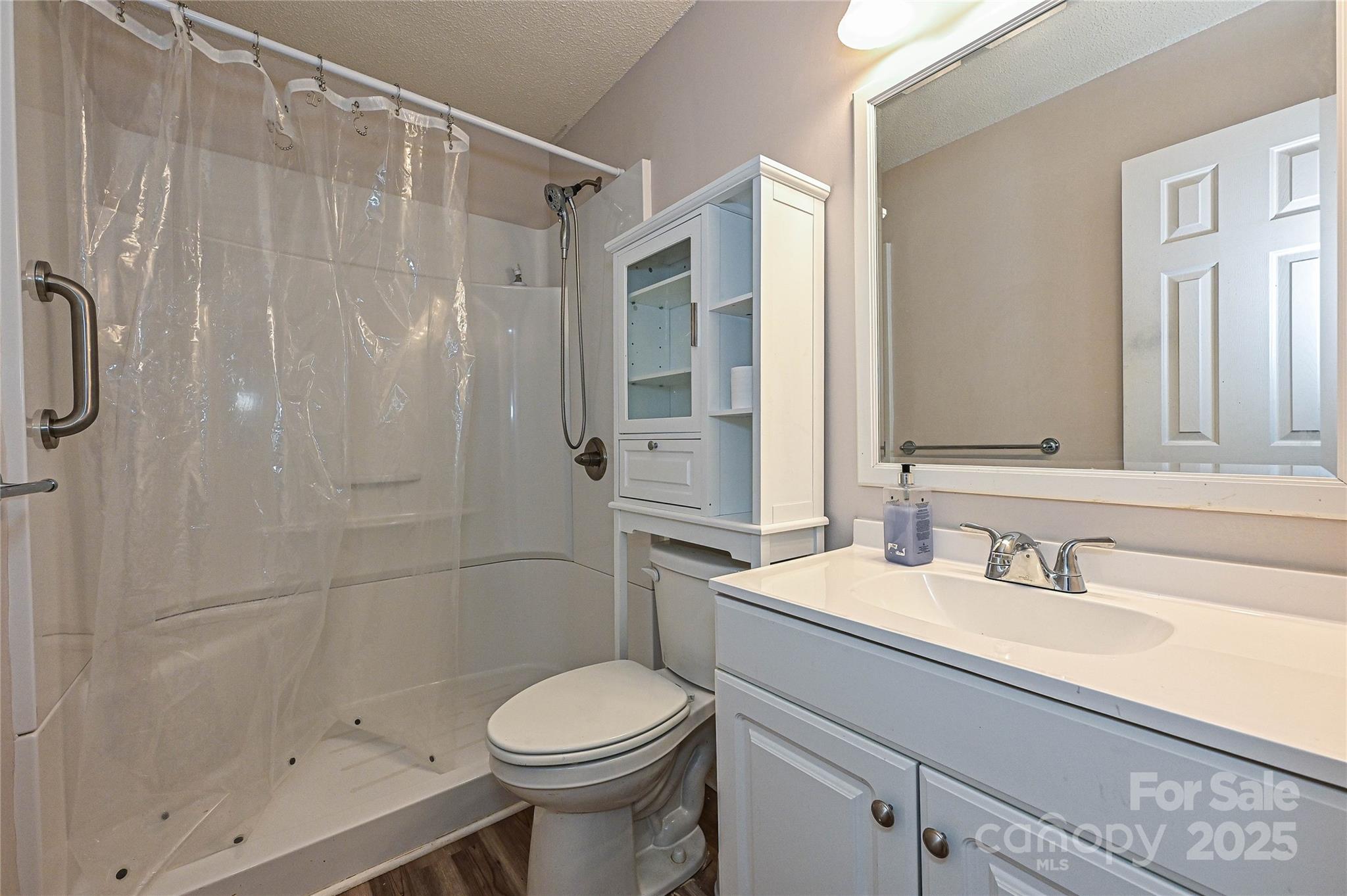 7705 Red Robin Trail Denver, NC 28037 - Photo 17 of 27 a bathroom with a sink a toilet and shower