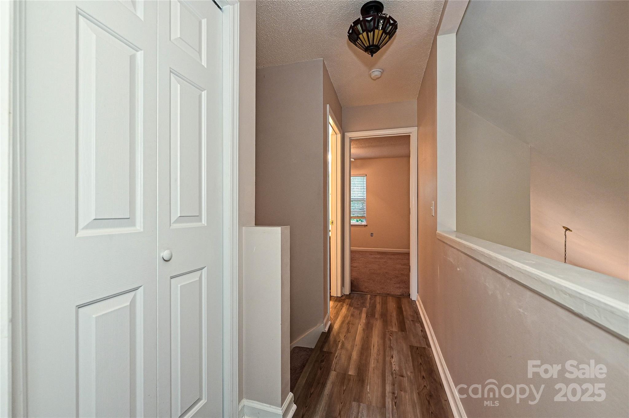 7705 Red Robin Trail Denver, NC 28037 - Photo 19 of 27 a view of a hallway with a wooden floor