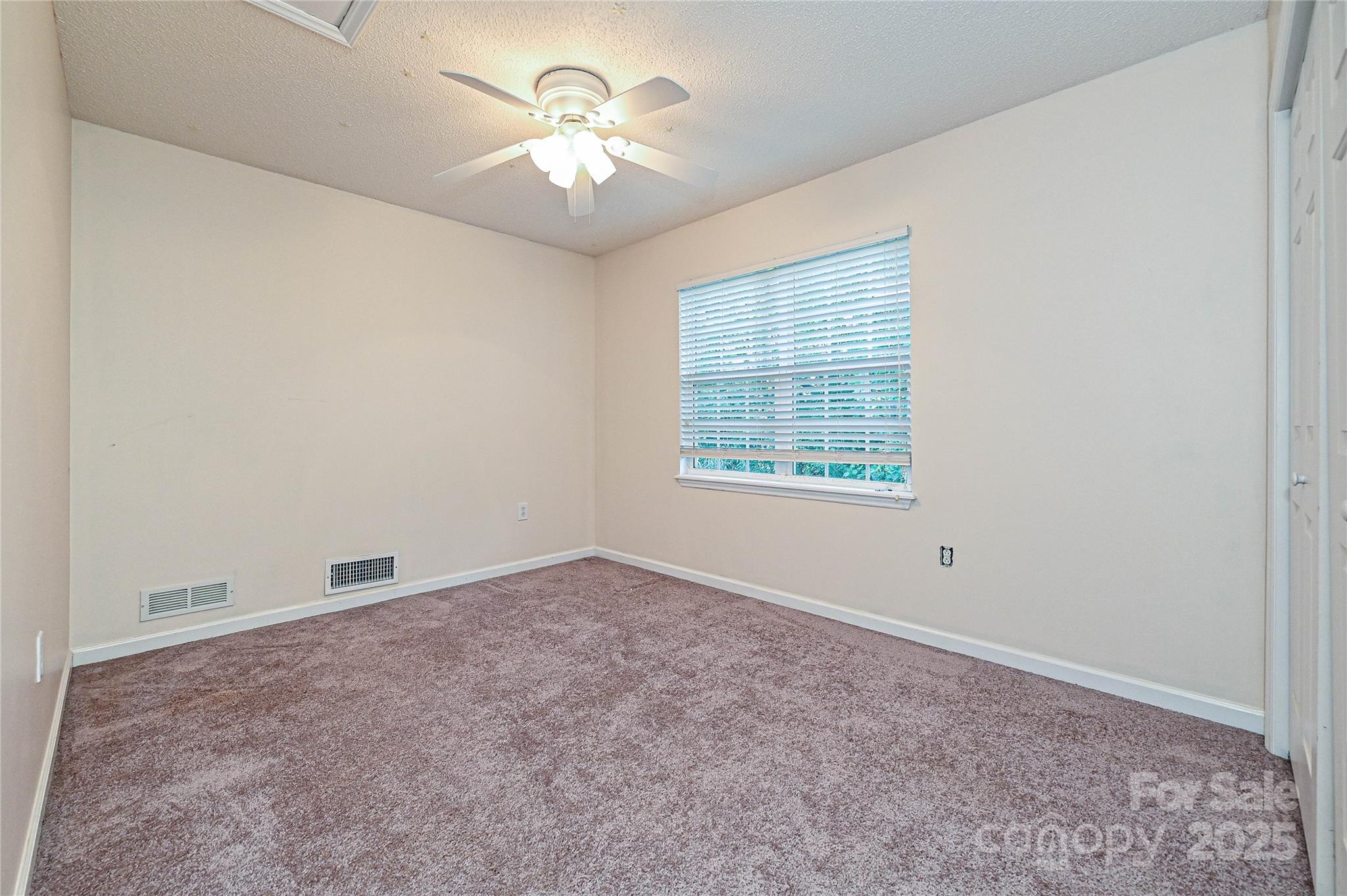 7705 Red Robin Trail Denver, NC 28037 - Photo 20 of 27 an empty room with chandelier fan and windows