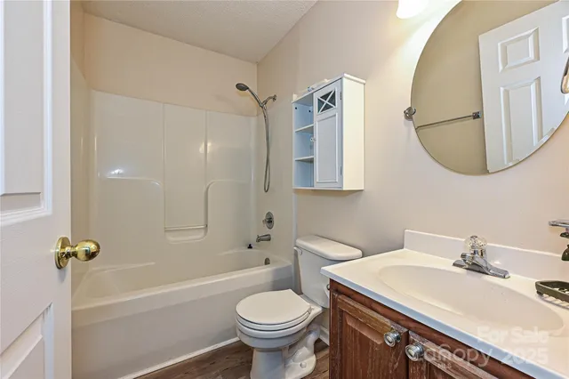 a bathroom with a sink toilet tub and shower
