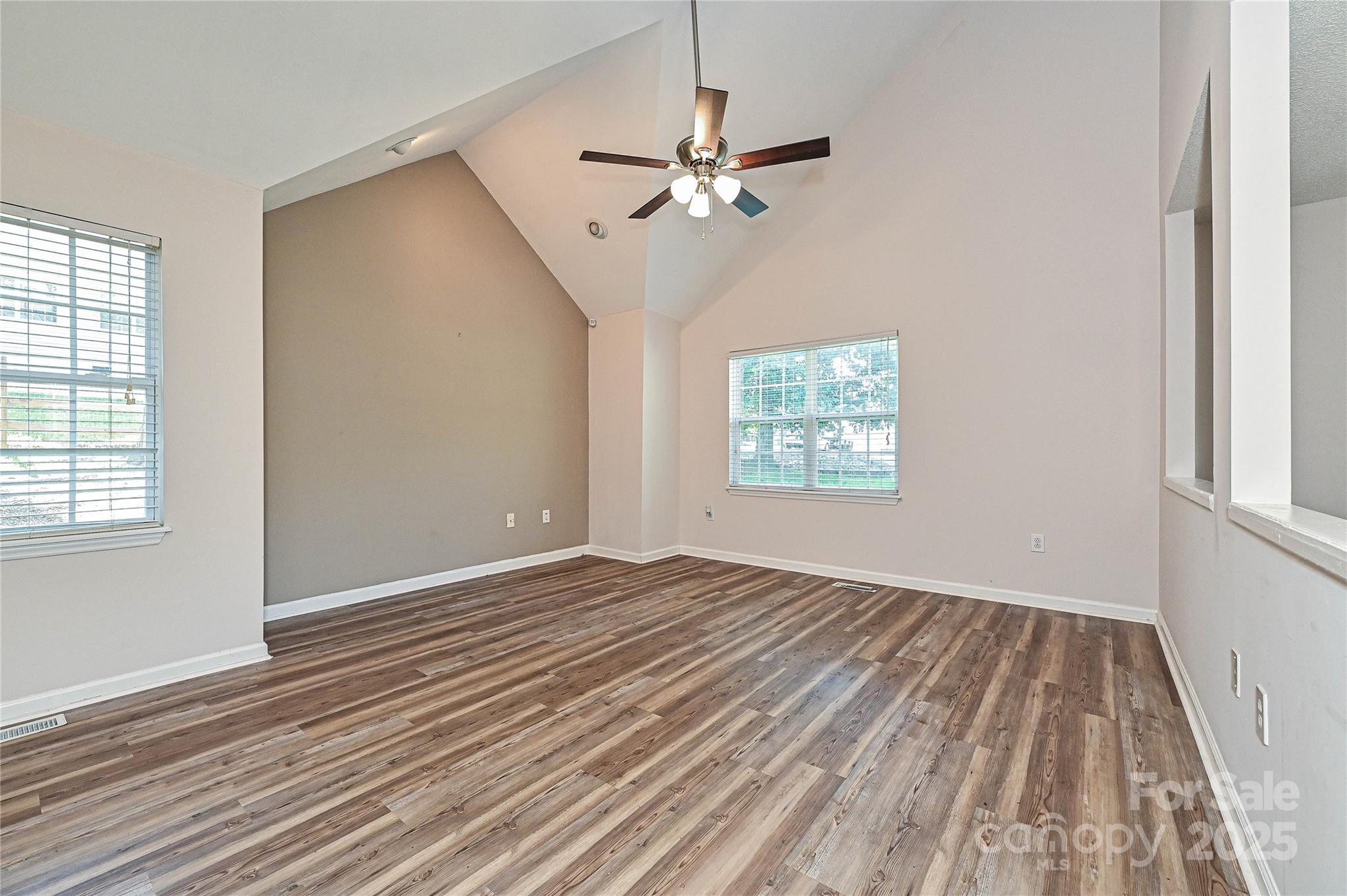 7705 Red Robin Trail Denver, NC 28037 - Photo 4 of 27 a view of an empty room with wooden floor and a window