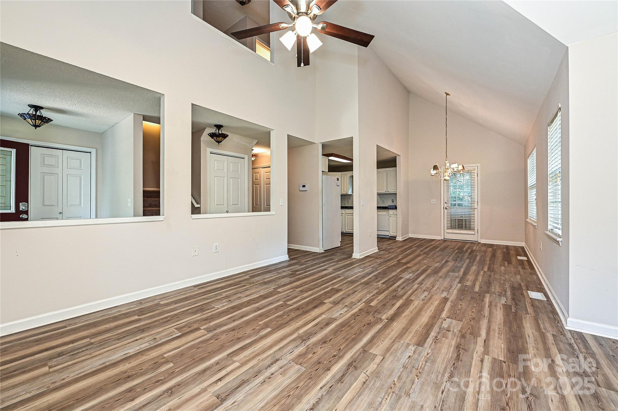 7705 Red Robin Trail Denver, NC 28037 - Photo 5 of 27 a view of an empty room with window and wooden floor