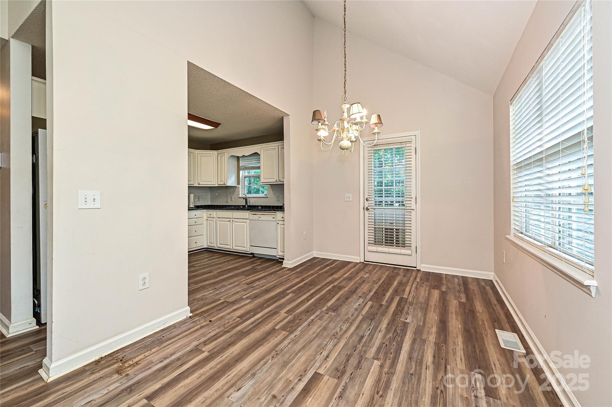 7705 Red Robin Trail Denver, NC 28037 - Photo 7 of 27 a view of a room with wooden floor kitchen view and a window