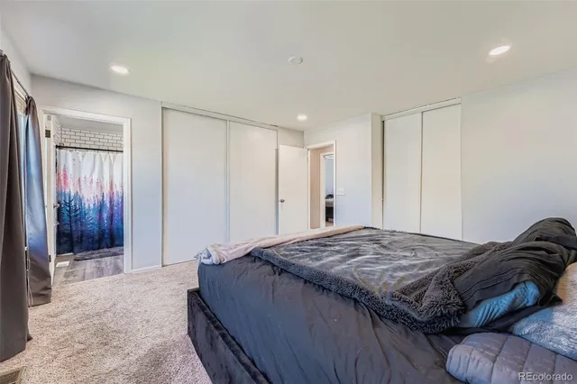 a bedroom with a bed and a mirror