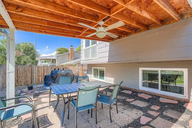 a view of a patio with table and chairs and potted plants