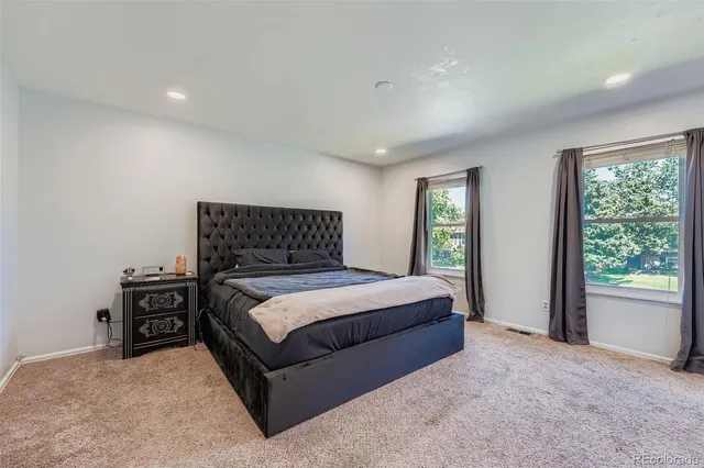 a bedroom with a bed and window