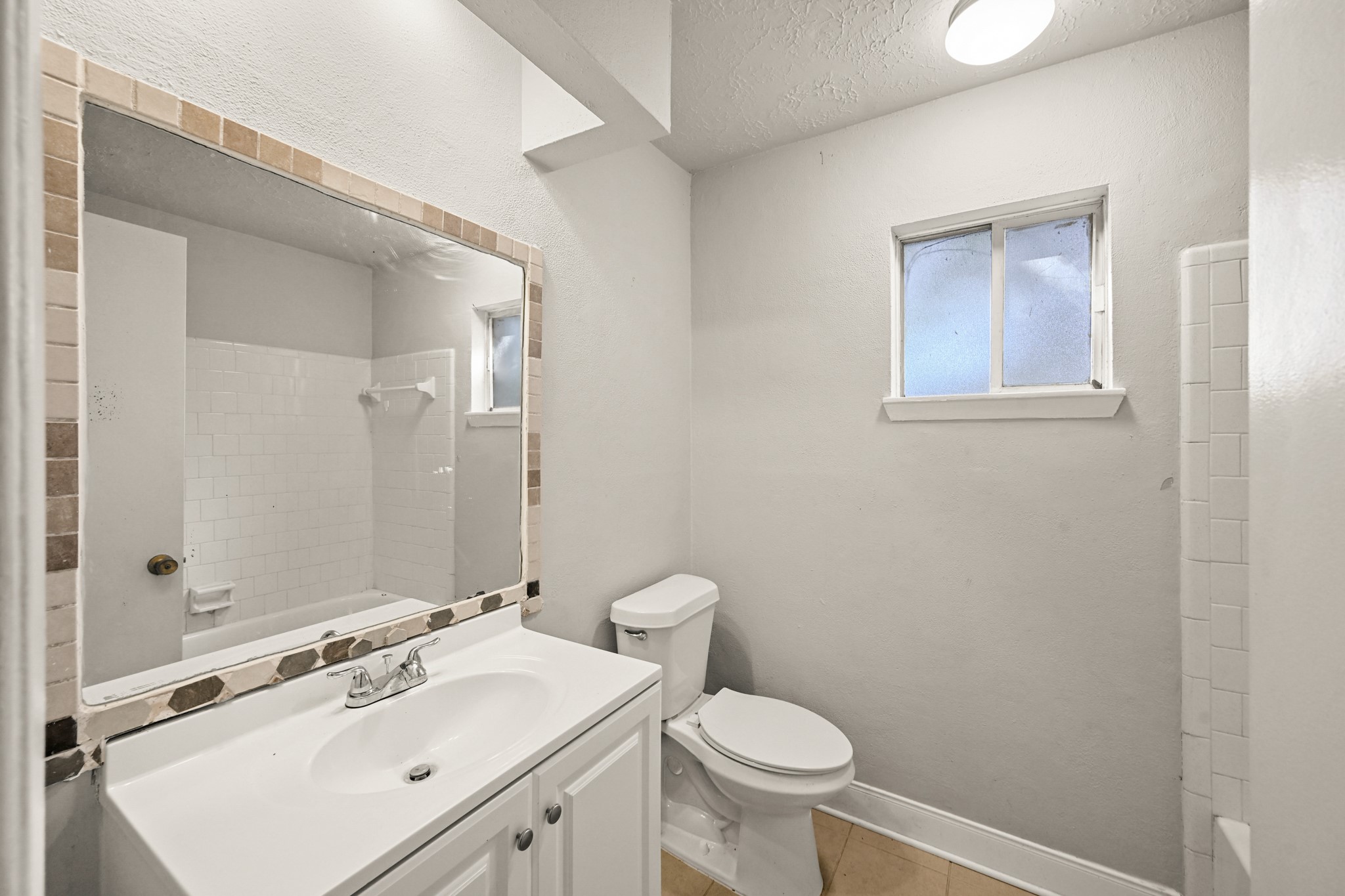 19302 Pocito Court Humble, TX 77346 - Photo 20 of 28 Secondary bathroom with tub/shower combo, one sink, and accented mirror.