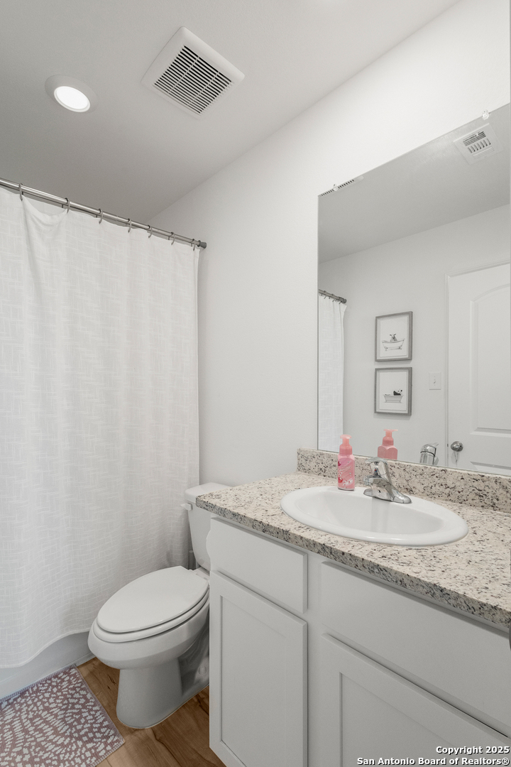 16025 Dickens Lytle, TX 78052 - Photo 12 of 15 a bathroom with a granite countertop sink mirror vanity and toilet