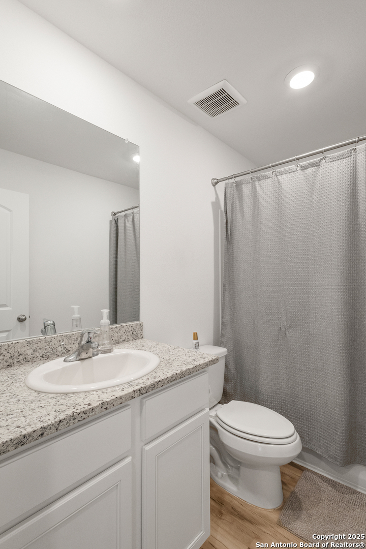 16025 Dickens Lytle, TX 78052 - Photo 14 of 15 a bathroom with a granite countertop sink toilet and shower