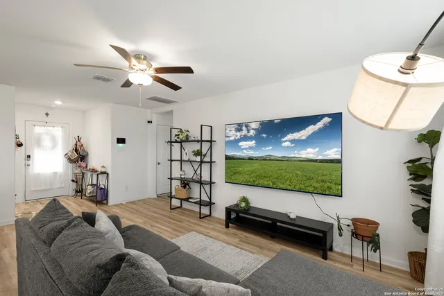 a living room with furniture and a flat screen tv