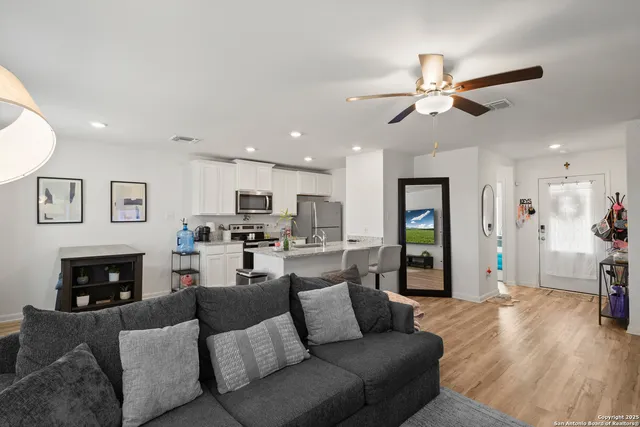a living room with furniture a fireplace and a flat screen tv