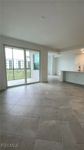 a view of kitchen with granite countertop white cabinets and stainless steel appliances