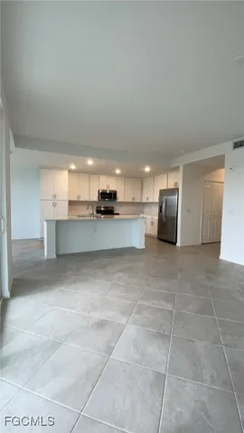 a kitchen with a refrigerator and a sink