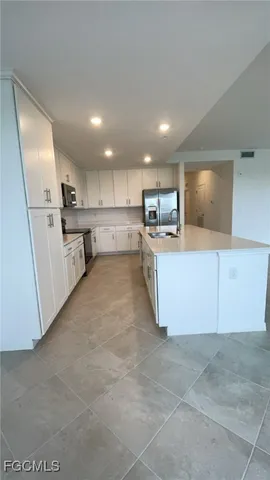 a large bathroom with a large mirror vanity and sink