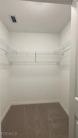 a spacious bathroom with a shower sink and mirror