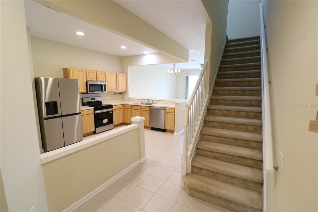 4866 Pond Ridge Drive Riverview, FL 33578 - Photo 10 of 38 a kitchen with cabinets and stainless steel appliances