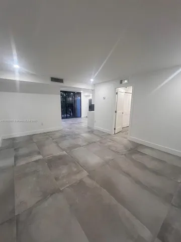 an empty room with a empty space and windows