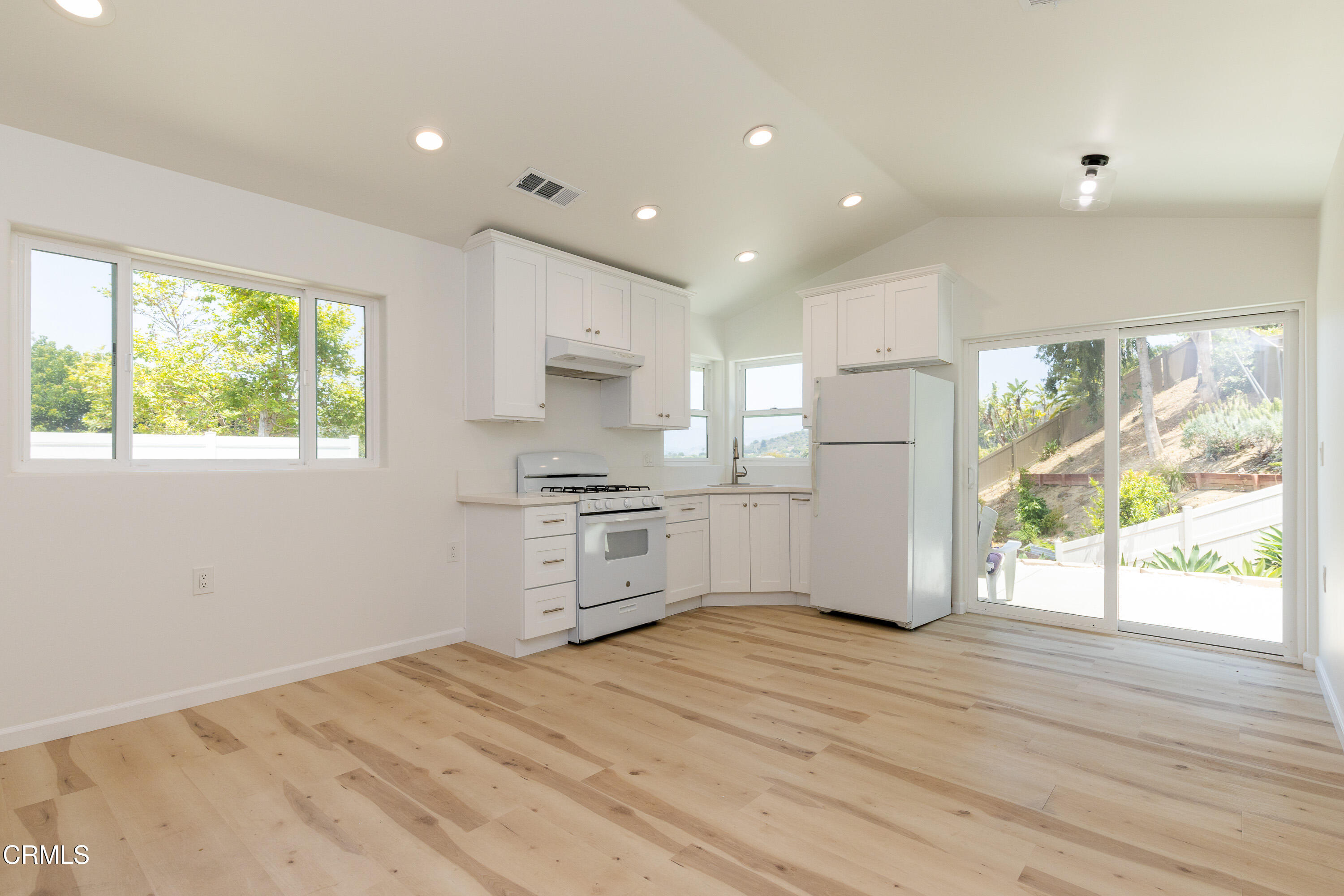 a kitchen with stainless steel appliances a refrigerator and a stove top oven
