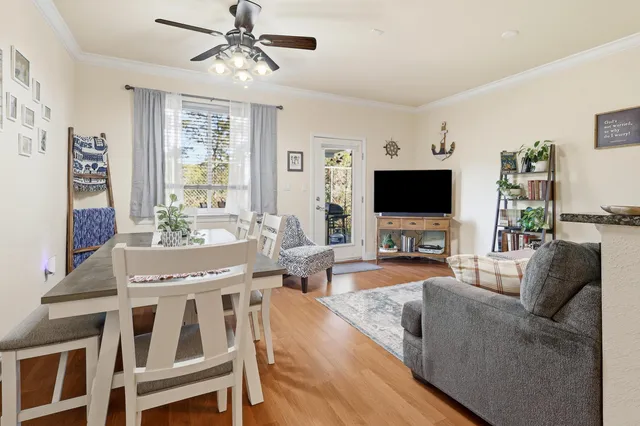 a living room with furniture wooden floor and a window