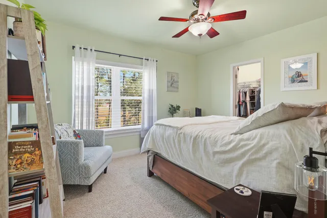 a bedroom with a large bed and a chandelier