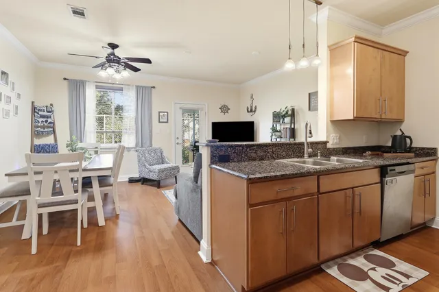 a kitchen with stainless steel appliances granite countertop a refrigerator and a sink