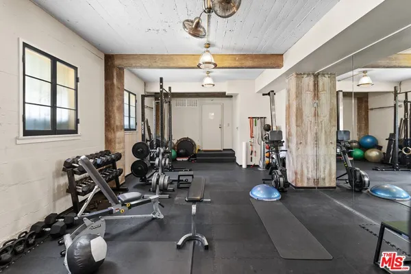 a room with lots of chairs and mirrors