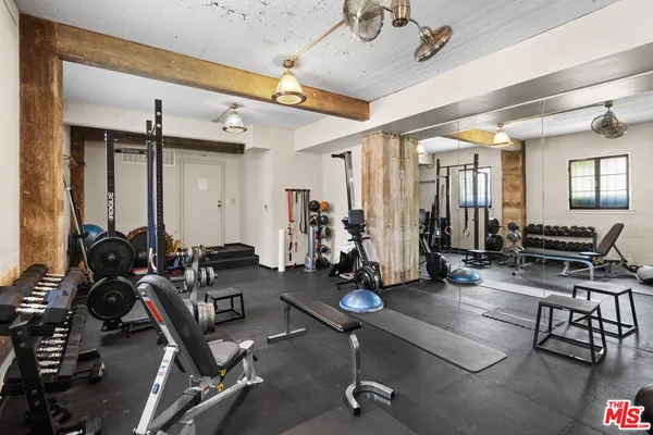 a room with gym equipment and a large window