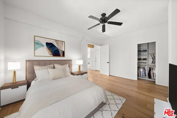a bedroom with a large bed and a chandelier