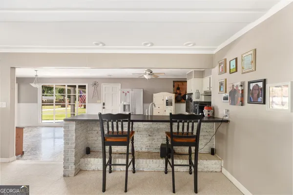 a view of a dining room with furniture and a potted plant